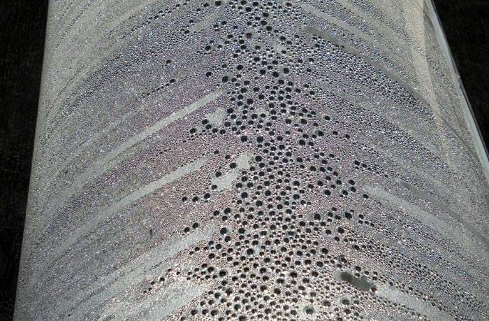 Closeup view of pure water droplets forming and dripping inside Clear Dome Solar Still Purifier/Pasteurizer