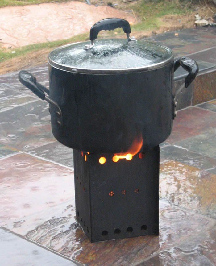 Click for larger view of prototype Wood Pellet Camp Stove in rain